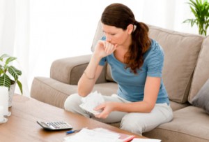 Anxious woman looking at finances: LawteryX Bankruptcy Blog