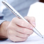 close up of person signing document with pen: Lawtery X Wills and Estate Planning Blog