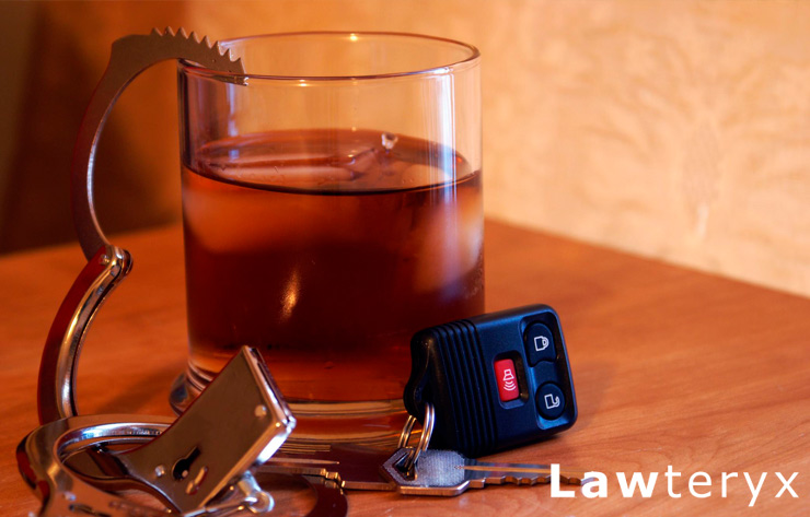 alcoholic drink sitting next to car keys and handcuffs on table