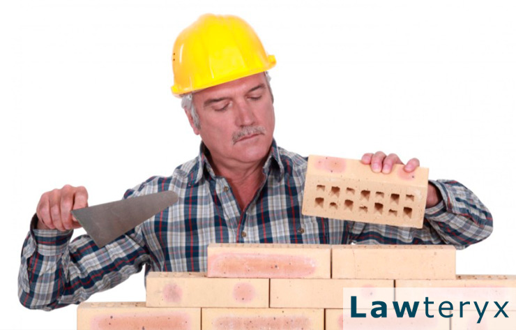 older construction worker laying bricks