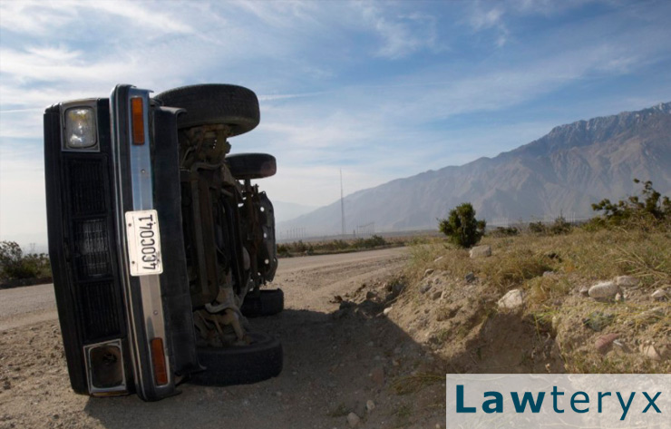 image of a car flipped on its side after a crash